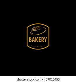 Bakery logo. Bread and spikelet on dark background. Bakery sign. 