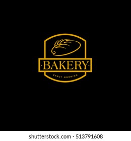 Bakery logo. Bread and spikelet on dark background. Bakery sign.