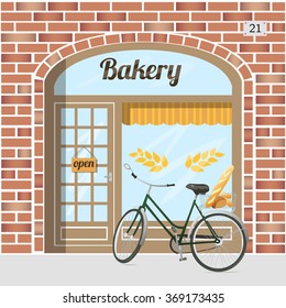 Bakery shop building. Red brick facade. Bicycle with bread. EPS 10 vector.