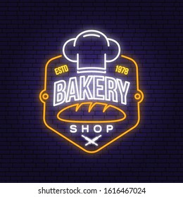 Bakery shop neon bright signboard, light banner. Vector. Concept for badge, shirt, label, print, stamp. Neon typography design with bread, text, chef hat silhouette. Template for restaurant identity