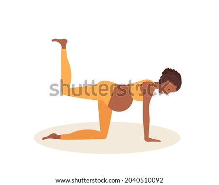 Balancing table yoga pose. Pregnant African American woman doing yoga. Cheerful positive young woman in sportswear doing exercises barefoot on floor mat. Prenatal Dandayanma Bharmanasana.