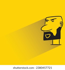 bald man with shadow on yellow background