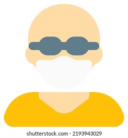 Bald man with specs having on mask for protection.