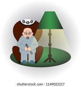 Bald old man with glasses and  beard sits in an armchair with a newspaper in the hands under the light of a floor lamp