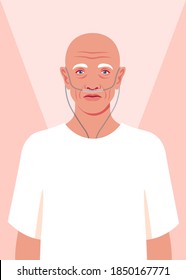 Bald senior man is standing in the hospital. Old cancer patient with a nasal breathing tube cannula feeling lonely at hospice. Health care for the elderly people. Coronavirus and respiratory therapy.