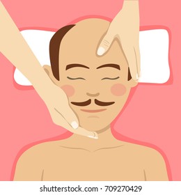 Bald-headed man having head massage in spa. Top view
