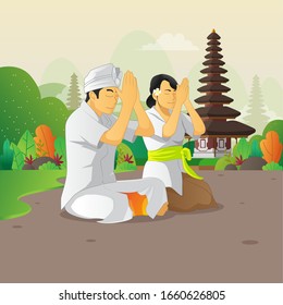 Balinese man and woman praying on the silent day celebration