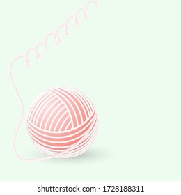 ball of woolen thread on a green background