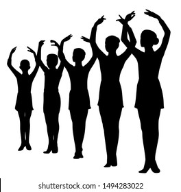 Ballet dancers standing in a row with raised hands