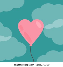 A balloon in the shape of a heart in the sky with clouds