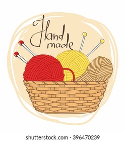 balls of yarn and knitting needles in basket isolated 