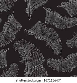 Banana leaves in a white outline on a black background. Separate elements located randomly. Seamless vector tropical pattern.