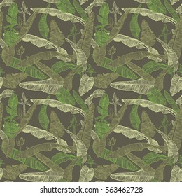 Banana palm leaves, flowers and branches. Decorative seamless vector botanical pattern on dark blue background.