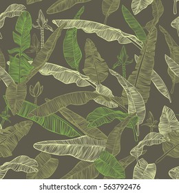 Banana palm leaves, flowers and branches. Decorative seamless vector botanical pattern on dark blue background.