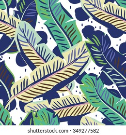 Banana palm leaves on the dot background. Vector seamless pattern with tropical plant.