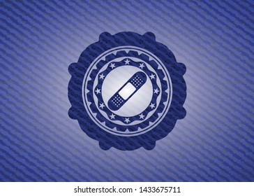 bandage plaster icon inside badge with denim texture