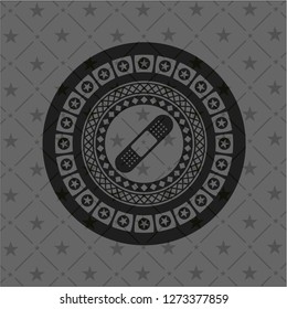 bandage plaster icon inside dark badge or emblem