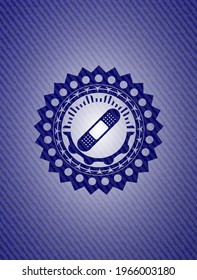 bandage plaster icon inside emblem with denim texture. 