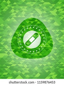 bandage plaster icon inside green mosaic emblem