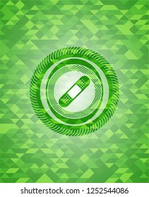 bandage plaster icon inside green emblem with triangle mosaic background