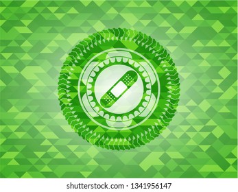 bandage plaster icon inside green mosaic emblem