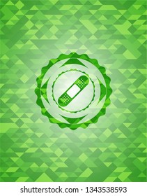 bandage plaster icon inside green emblem with mosaic ecological style background