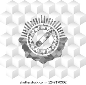 bandage plaster icon inside grey badge with geometric cube white background