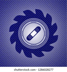 bandage plaster icon inside jean or denim emblem or badge background