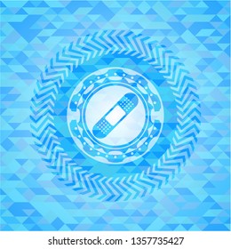 bandage plaster icon inside light blue emblem with triangle mosaic background
