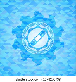 bandage plaster icon inside light blue emblem with triangle mosaic background