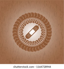 bandage plaster icon inside realistic wood emblem