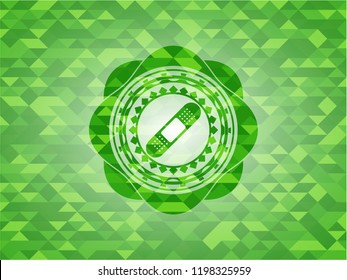 bandage plaster icon inside realistic green emblem. Mosaic background
