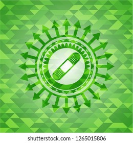bandage plaster icon inside realistic green emblem. Mosaic background