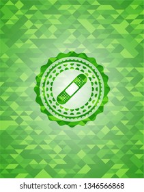 bandage plaster icon inside realistic green mosaic emblem