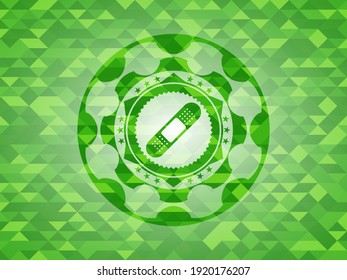 bandage plaster icon inside realistic green mosaic emblem. 