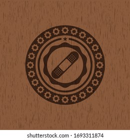 bandage plaster icon inside retro style wood emblem