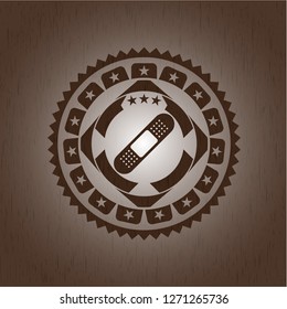 bandage plaster icon inside wood emblem. Vintage.