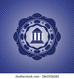 bank icon inside badge with denim background. 