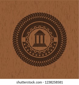 bank icon inside badge with wooden background