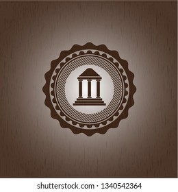 bank icon inside badge with wooden background