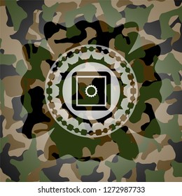 bank safe icon inside camouflaged emblem