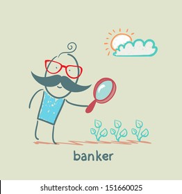 banker is looking through a magnifying glass on plants
