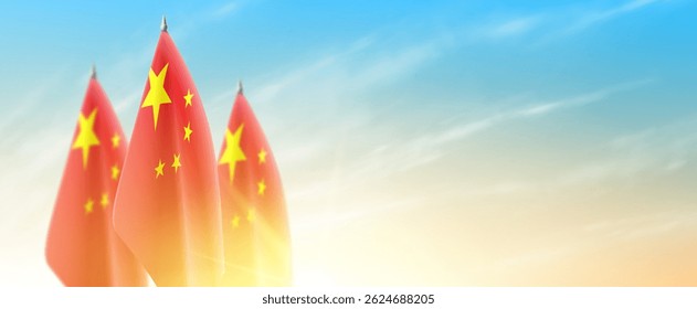Banner with Chinese flags. Chinese flags isolated on cloudy sky at sunrise. Realistic flags for decoration Chinese events, holidays. Vector illustration.
