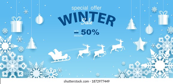 Banner, discounts up to -50% on NEW YEAR'S and CHRISTMAS HOLIDAYS winter sale, special offer. Santa Claus with deer. Postcard, gifts, box, toys on layered paper on a blue background. Cut out of paper