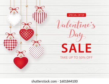 Banner for Valentine's Day Sale. Beautiful background with fabric hearts and bows on wooden texture. Vector illustration.