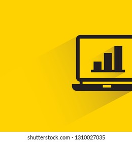 bar chart in laptop with shadow on yellow background