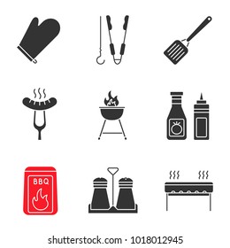 Barbecue glyph icons set. BBQ. Oven mitt, skewer and tongs, spatula, grilled sausage, grill, ketchup and mustard, coal, salt and pepper shakers. Silhouette symbols. Vector isolated illustration