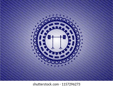 barbell on rack icon inside emblem with jean texture