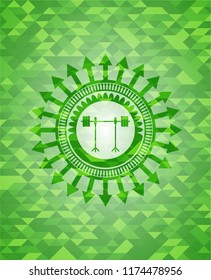 barbell on rack icon inside green emblem with triangle mosaic background