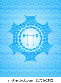 barbell on rack icon inside water wave representation style badge.